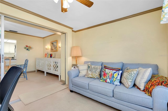 living room featuring ornamental molding, light carpet, and ceiling fan