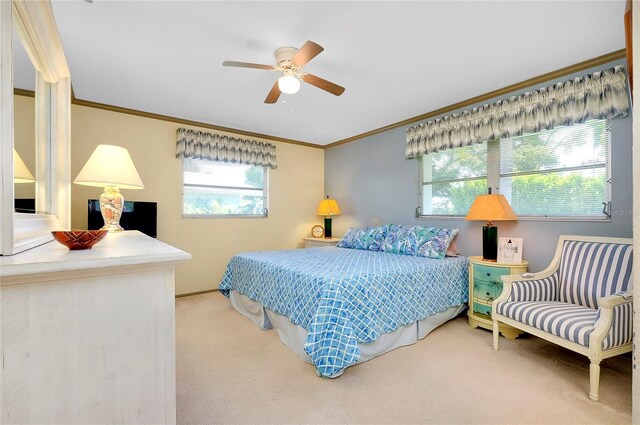 bedroom with ornamental molding, ceiling fan, and carpet floors