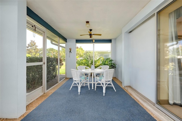 sunroom / solarium featuring plenty of natural light and ceiling fan