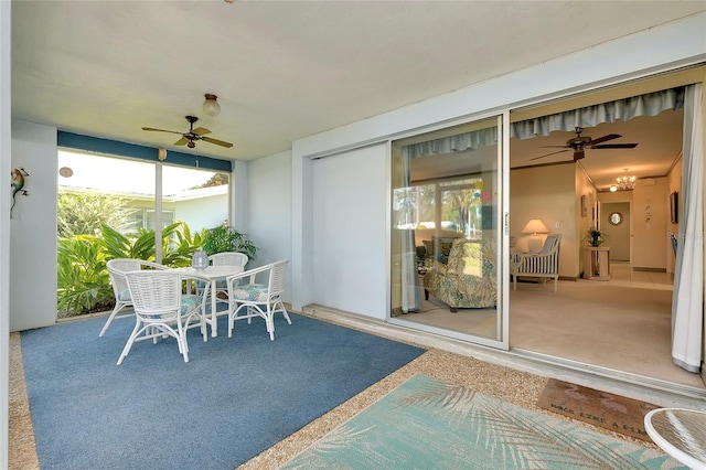 sunroom featuring ceiling fan