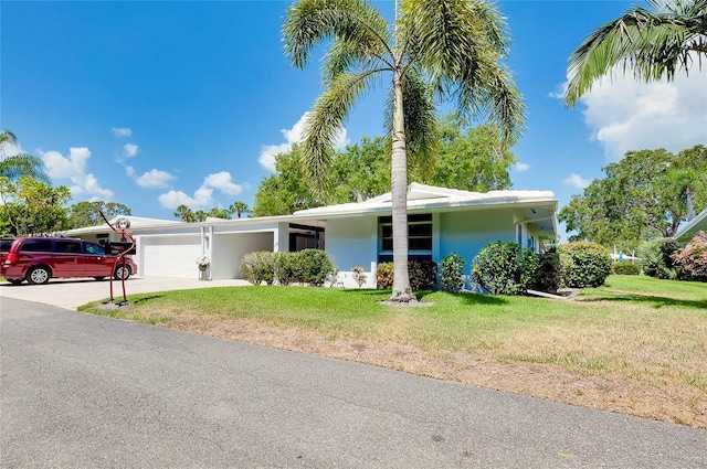 view of front facade with a garage and a front lawn