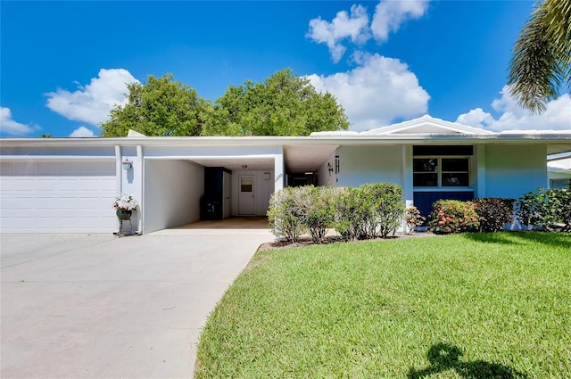 view of front facade with a garage, a carport, and a front yard