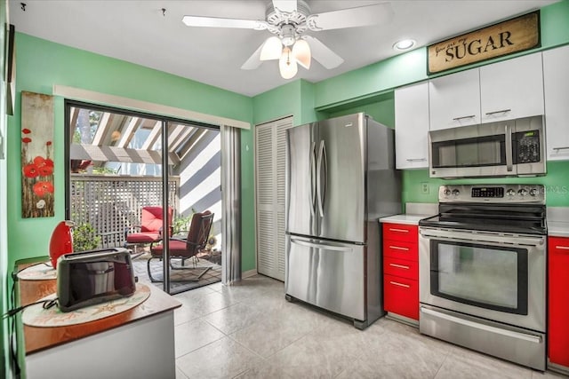 kitchen featuring light tile patterned floors, stainless steel appliances, white cabinetry, and ceiling fan