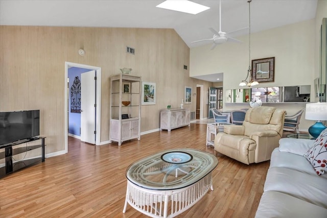 living room featuring ceiling fan, high vaulted ceiling, and hardwood / wood-style flooring