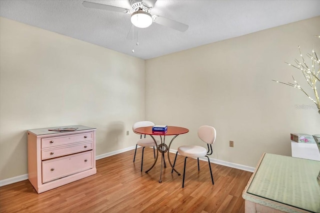 rec room featuring a textured ceiling, light hardwood / wood-style floors, and ceiling fan