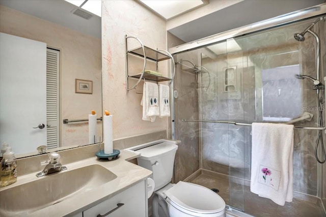 bathroom featuring vanity, toilet, and an enclosed shower