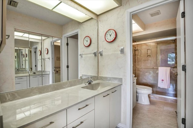 bathroom featuring tile patterned flooring, vanity, and toilet