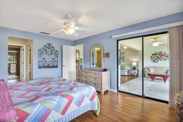 bedroom with wood-type flooring, ceiling fan, a textured ceiling, and a closet