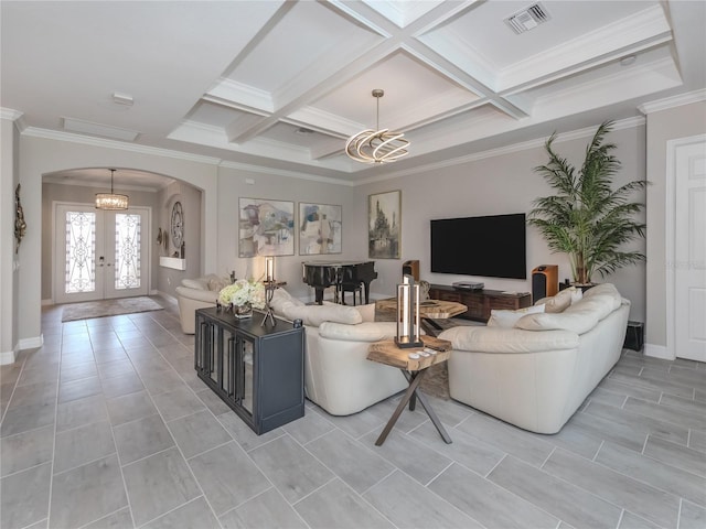 tiled living room featuring a chandelier, ornamental molding, french doors, and coffered ceiling