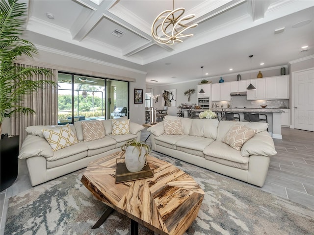 living room with beam ceiling, an inviting chandelier, coffered ceiling, and ornamental molding