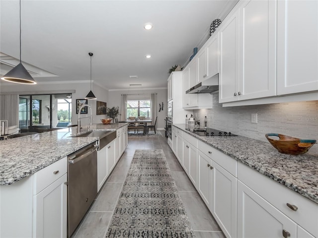 kitchen featuring appliances with stainless steel finishes, ornamental molding, pendant lighting, white cabinets, and sink