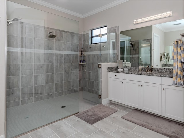 bathroom featuring a shower with shower door, vanity, tile patterned flooring, and crown molding