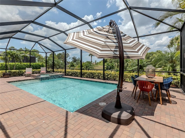 view of swimming pool with glass enclosure, an in ground hot tub, and a patio