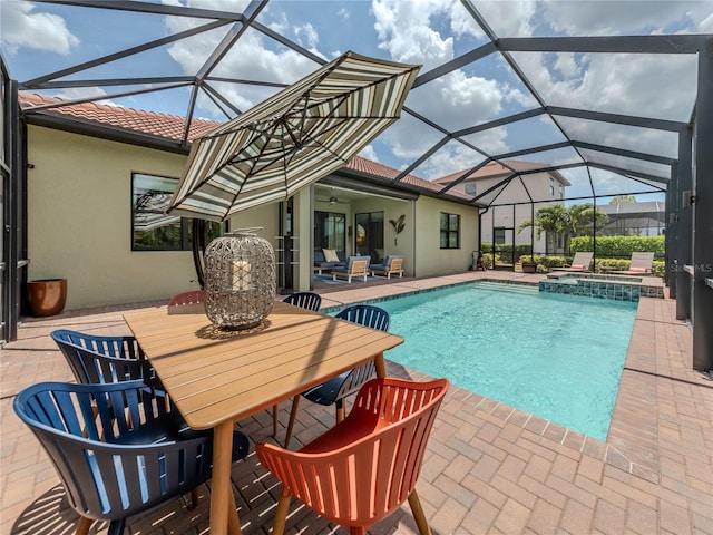 view of pool with an in ground hot tub, a lanai, and a patio area