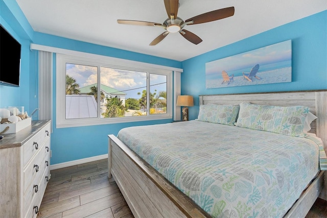 bedroom with ceiling fan and dark hardwood / wood-style flooring