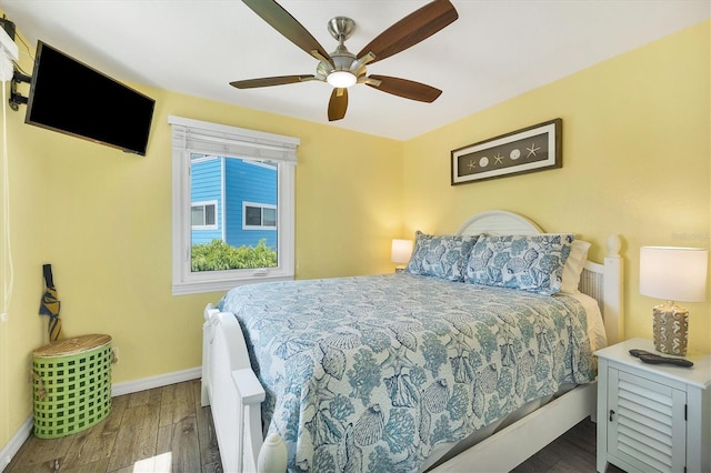 bedroom with ceiling fan and dark hardwood / wood-style flooring