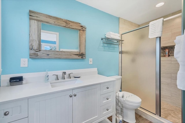 bathroom featuring vanity, toilet, and walk in shower