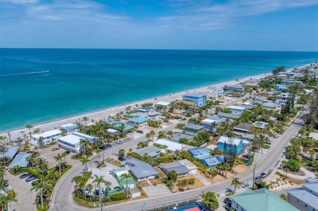 birds eye view of property with a water view and a view of the beach