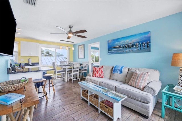 living room with hardwood / wood-style flooring and ceiling fan