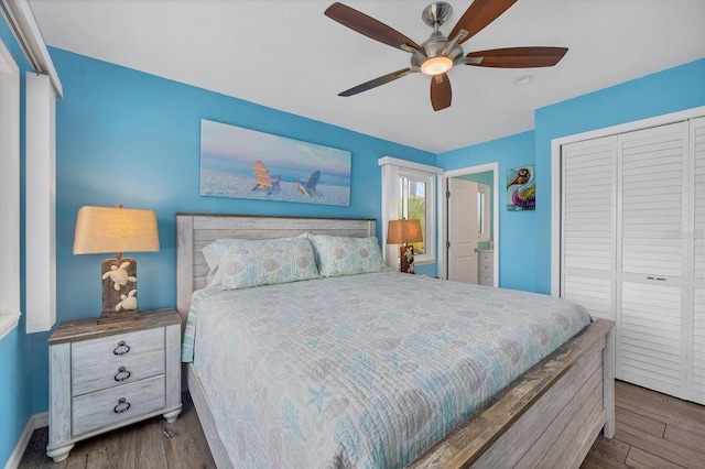 bedroom featuring dark hardwood / wood-style flooring, a closet, and ceiling fan