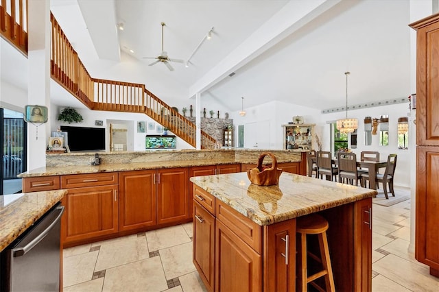 kitchen with light stone countertops, beamed ceiling, dishwasher, brown cabinets, and ceiling fan with notable chandelier