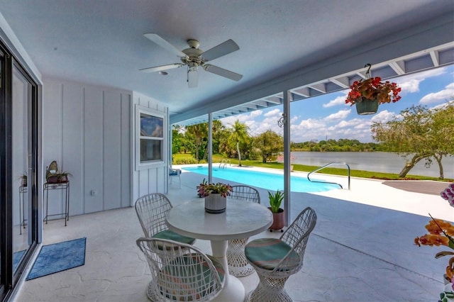 exterior space featuring ceiling fan and a water view