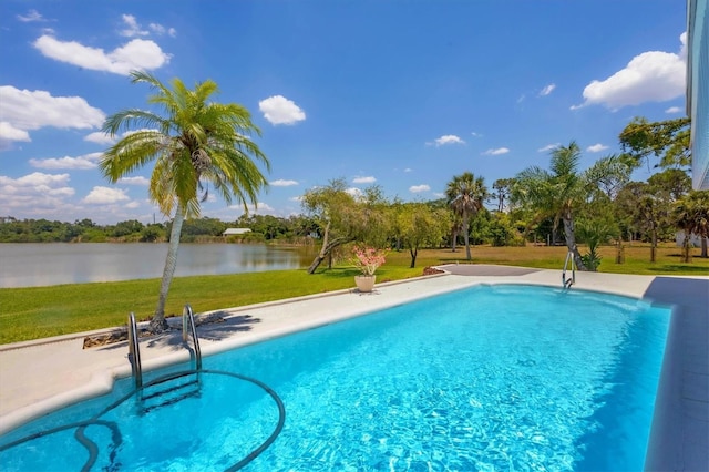 outdoor pool featuring a yard and a water view