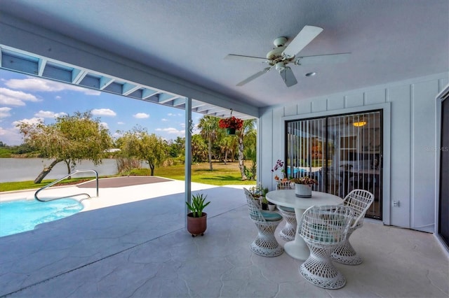 view of patio / terrace featuring a ceiling fan and an outdoor pool