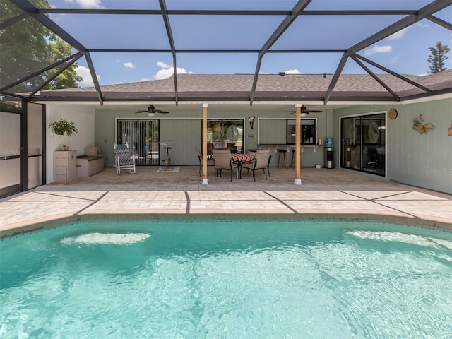 view of swimming pool featuring a lanai, ceiling fan, and a patio area