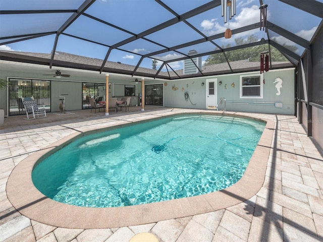 view of pool with ceiling fan, a lanai, and a patio