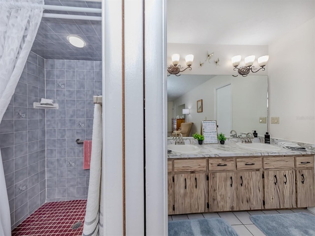 bathroom featuring tile patterned floors, vanity, and tiled shower