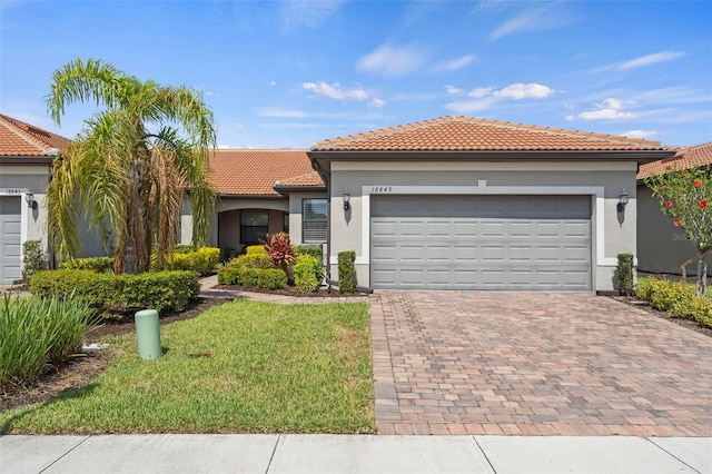 mediterranean / spanish home with a garage and a front yard