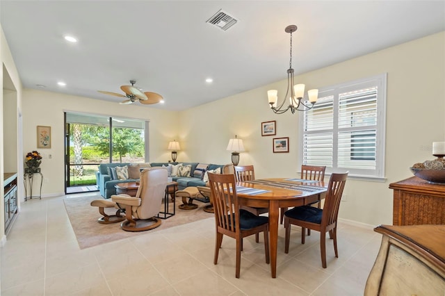 dining room featuring light tile patterned floors and ceiling fan with notable chandelier