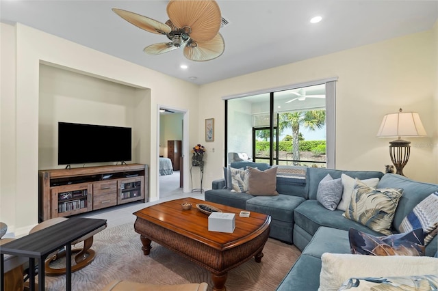 living room with ceiling fan and tile patterned floors