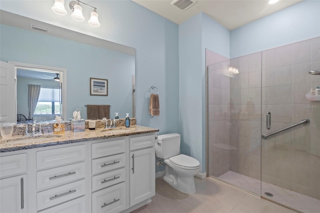 bathroom with tile patterned floors, toilet, an enclosed shower, and vanity