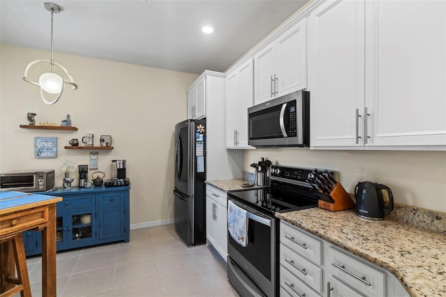 kitchen featuring light tile patterned floors, stainless steel appliances, hanging light fixtures, light stone countertops, and white cabinets