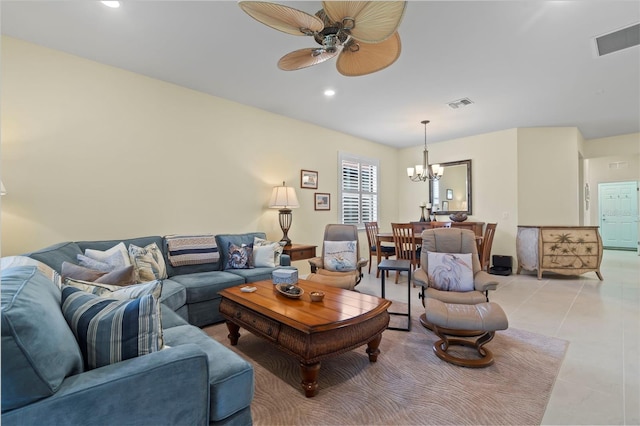 tiled living room with ceiling fan with notable chandelier