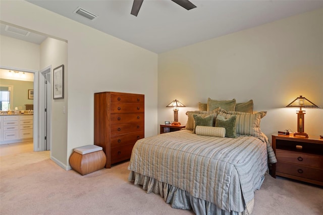 carpeted bedroom featuring ceiling fan and ensuite bathroom