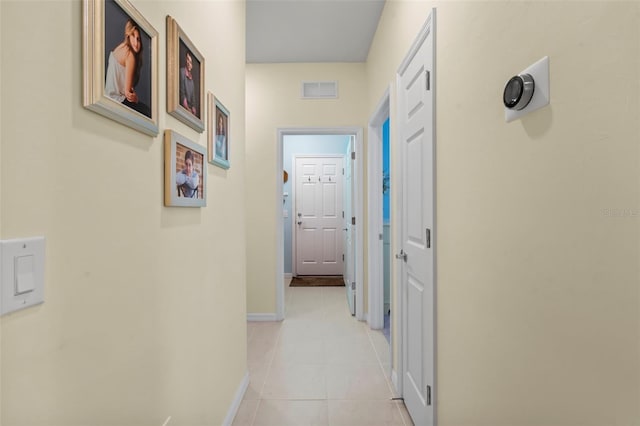 hall featuring light tile patterned floors