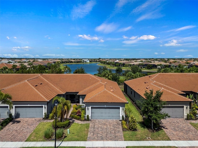 view of front of property featuring a garage and a water view