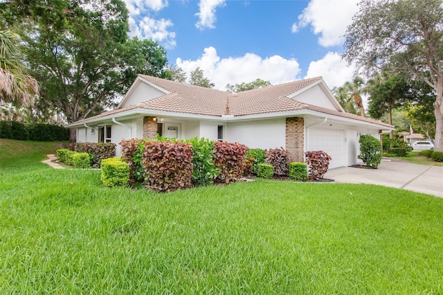 view of side of home with a lawn and a garage