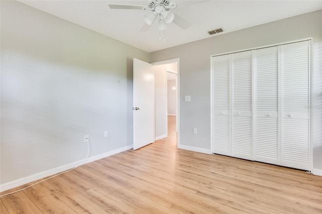 unfurnished bedroom with a closet, light hardwood / wood-style flooring, and ceiling fan