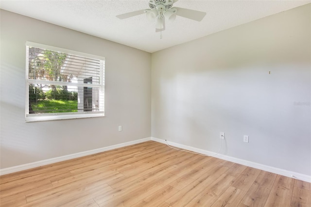 unfurnished room with a textured ceiling, ceiling fan, light hardwood / wood-style flooring, and plenty of natural light