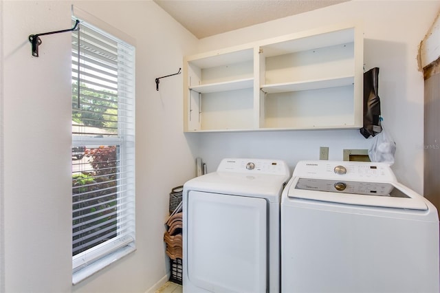 washroom featuring washing machine and clothes dryer