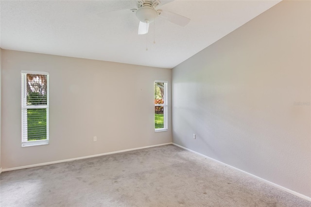 empty room with ceiling fan, carpet floors, and a healthy amount of sunlight