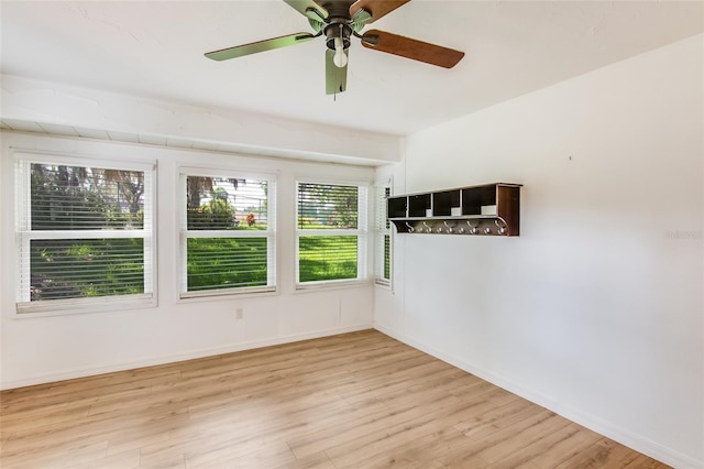 unfurnished room featuring light wood-type flooring and ceiling fan