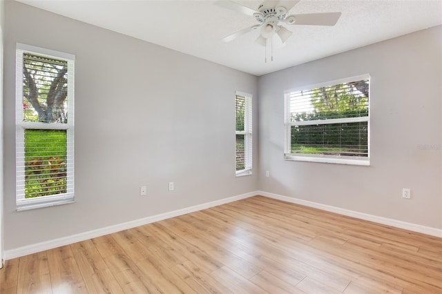 unfurnished room with ceiling fan and light hardwood / wood-style flooring