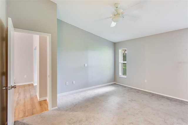 empty room with ceiling fan and light colored carpet