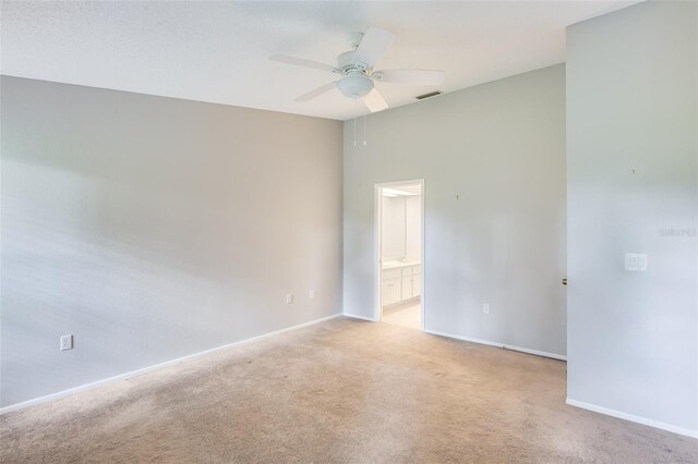 carpeted spare room with ceiling fan