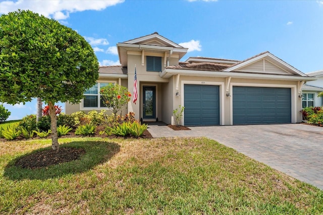 view of front of property featuring a garage and a front lawn